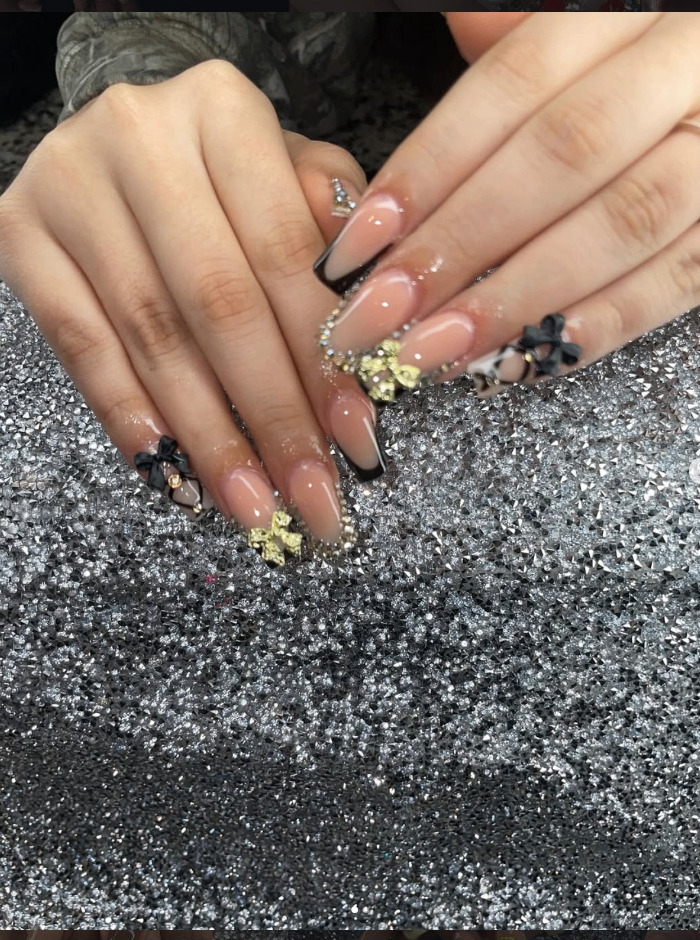 Gold and black french tip nails by Ailyn